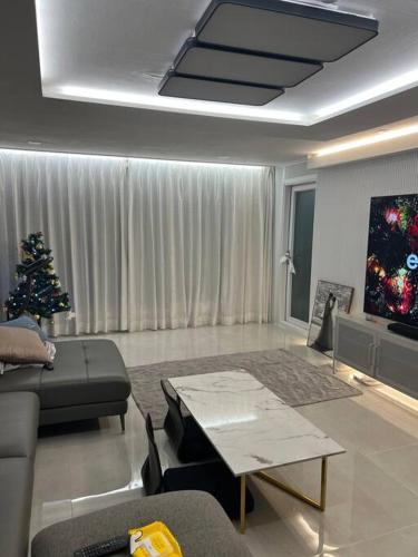 a living room with a christmas tree and a couch at Cozy Space with Modern Interior in Hwaseong in Hwaseong