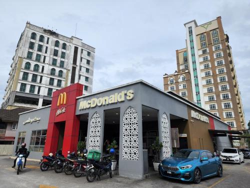 a car parked in front of a store with motorcycles at The Viana Apartment 1 in Kota Bharu