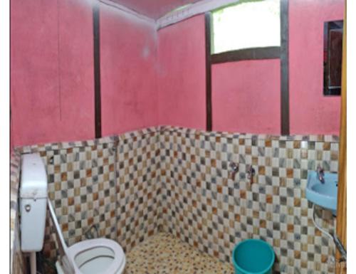 a bathroom with a toilet and a sink at Rishi River Cottage, West Bengal in Pedong