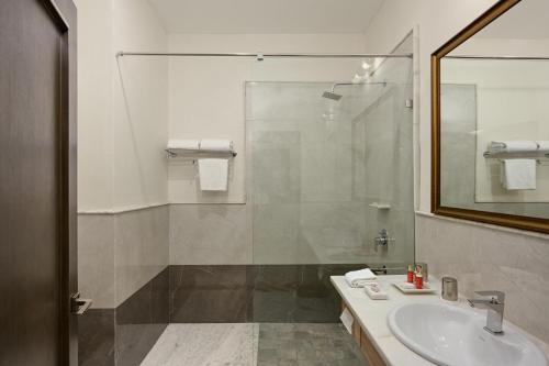 a bathroom with a sink and a shower at Fateh Vilas by Fateh Collection in Udaipur
