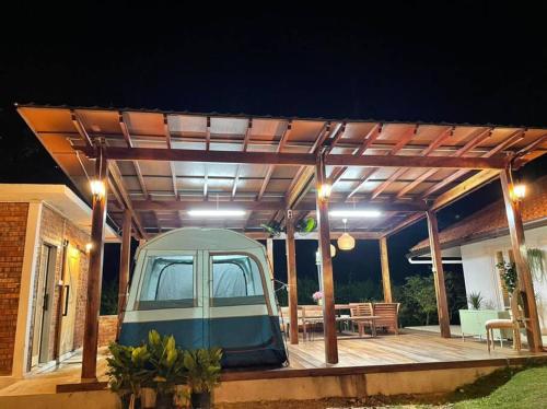 a gazebo on a deck at night at Private Homestay with 2 bedroom and comfort tent in Bentong