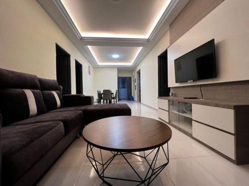 a living room with a couch and a table at Stobericekelathomestaymuslim's in Cameron Highlands