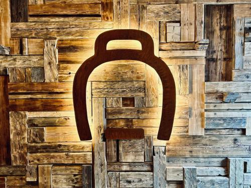 a wooden door with a large handle on a wall at Hameau des Prodains - Résidence in Morzine