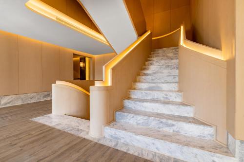 a set of stairs in a building with lights at Mansard Riyadh, a Radisson Collection Hotel in Riyadh