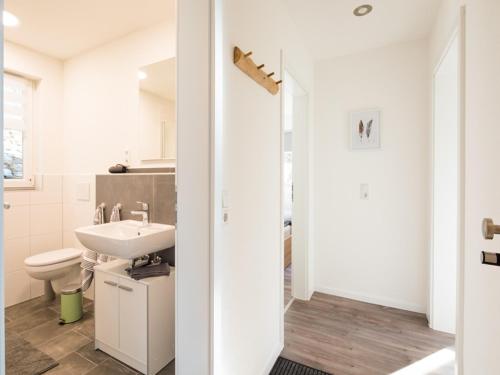 a white bathroom with a sink and a toilet at Zur Altstadt in Monschau