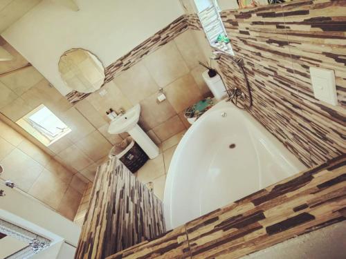 a bathroom with a large tub and a sink at Villa Saira-Holiday villa across the beach! in KwaDukuza