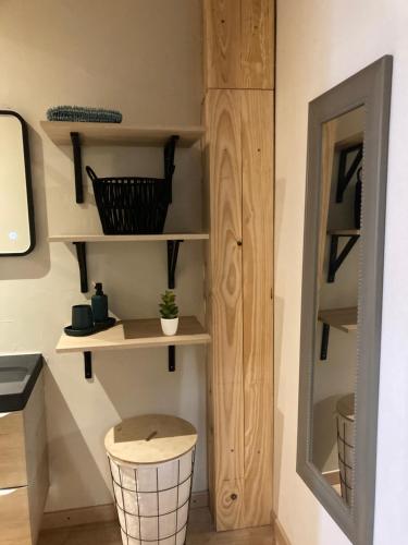 a room with wooden shelves and a stool at Maison Fontrabiouse in Fontrabiouse