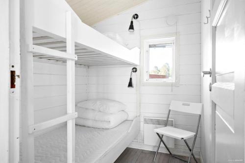 a small white room with a bunk bed and a ladder at First Camp Mörudden-Karlstad in Gunnarskär