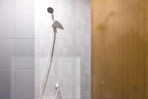a shower with a shower head in a bathroom at Graha Asri Syariah in Waru