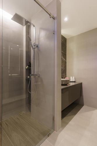 a shower with a glass door in a bathroom at Fifth Pattaya Jomtien By Shiwalai Int in Jomtien Beach