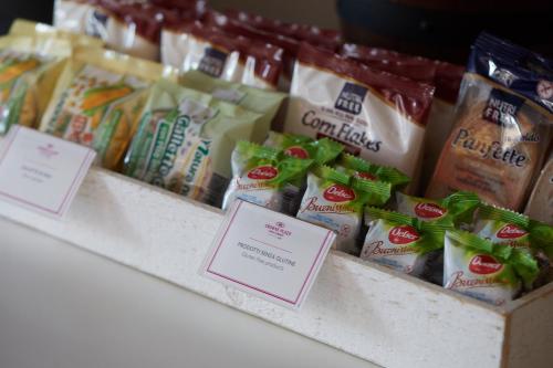 a store shelf with different types of food on display at Crowne Plaza Verona Fiera by IHG in Verona
