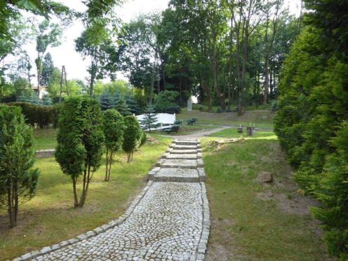a stone path in a park with trees at VIILLA REZIDENCE in Kudowa-Zdrój
