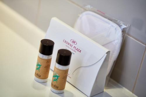 two bottles of essential oils sitting next to a box at Crowne Plaza Verona Fiera by IHG in Verona