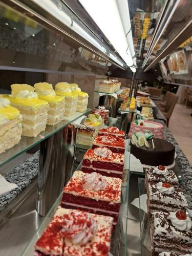 a buffet line with many different types of cakes at Naviti Warwick Al Khobar in Al Khobar