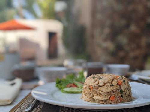 a white plate with a sandwich on a table at WAKA VILLA Private Pool Resort & Spa - Adults Only in Siem Reap