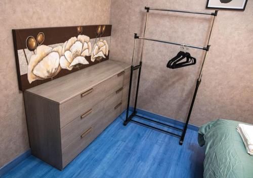 a bedroom with a closet with a dresser and a bed at Maison de Ville restylée avec jardin, proche gare in Dunkerque