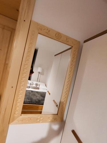 a mirror in a room with a bed at Pokoje u Dany Witów in Witów