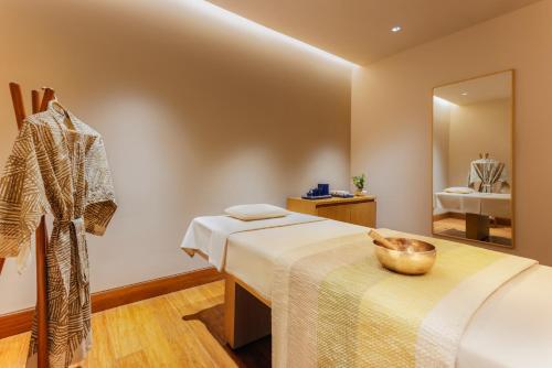 a room with two beds and a mirror at Six Senses Vana - A Wellness Retreat in Dehradun