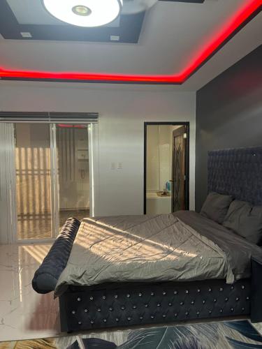 a bedroom with a bed with a red light on it at New build beautiful Apartment in Dagupan
