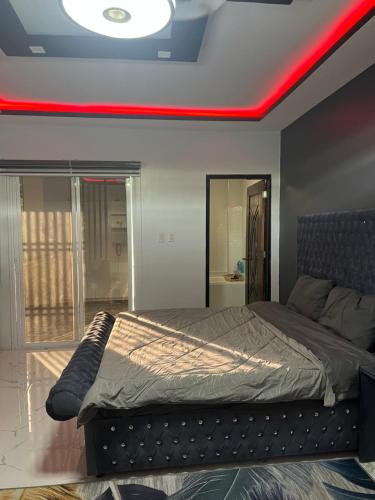a bedroom with a bed with a red light on it at Pike Guest House in Dagupan