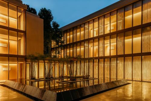 a building with two benches in front of it at Six Senses Vana - A Wellness Retreat in Dehradun