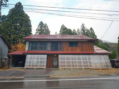 a house that is sitting on the side of a street at WAY SHIRAKAWAGO - Free Parking and Newly Opened 2022 WAY SHIRAKAWAGO in Shirakawa