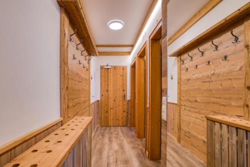 a hallway with wooden walls and a wooden bench at Appartement Hofmann in Königsleiten