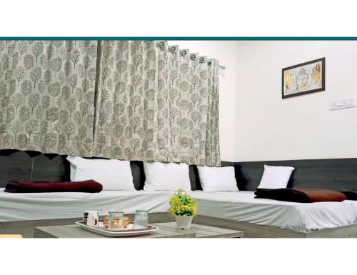 um quarto de hotel com uma cama e uma cortina em The Rudra Homestay, Garudeshwar em Garudeshwar