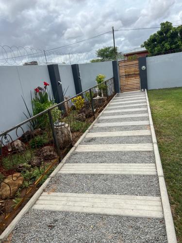 a stairway leading to a garden with a wooden door at Home@Amalia’s in Rundu