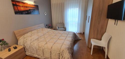 a bedroom with a bed and a table and a chair at Bed and breakfast Venice Friends in Mestre