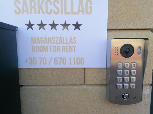 a remote control is attached to a sign on a wall at Sarkcsillag teljes családiház- Star Complete Family House in Szeged