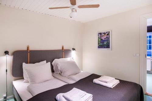 a bedroom with a bed with two towels on it at The Townhouse by Daniel&Jacob's in Copenhagen