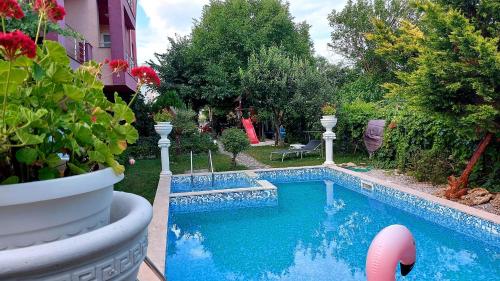 a swimming pool in a yard next to a house at Sunny houm in Nesebar
