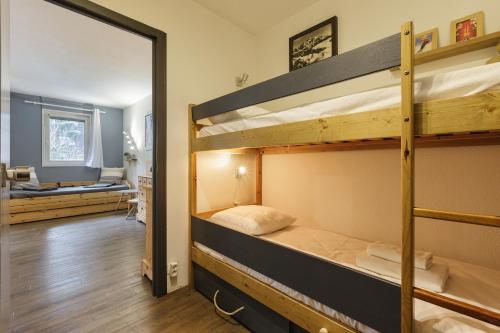 a room with two bunk beds and a mirror at Rivière 210 - Happy Rentals in Chamonix