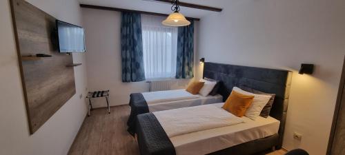 Postel nebo postele na pokoji v ubytování Hotel Bacchus