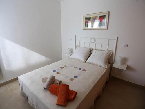 a bedroom with a bed with two towels on it at Villa Marina Calan Blanes in Cala en Forcat