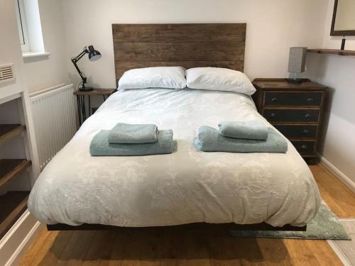 a bedroom with a bed with two pillows on it at Self contained annex in the Vale of Belvoir in Bottesford