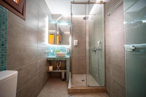 a bathroom with a shower and a sink at Antonia Apartments in Fira