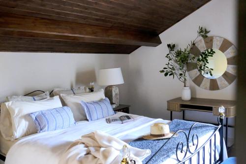 a bedroom with a large white bed and a mirror at Villa Várzea - Country Suite in Ginetes