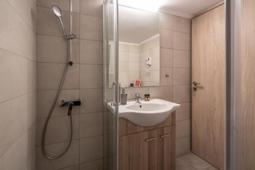 a bathroom with a sink and a shower at Modern Apartment in Exarchia in Athens