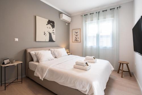a bedroom with a large bed with towels on it at Modern Apartment in Exarchia in Athens