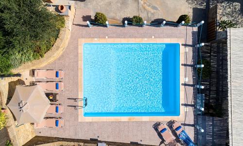 an overhead view of a swimming pool with an umbrella at Cretan Kera Villa Heated Pool in Kerá