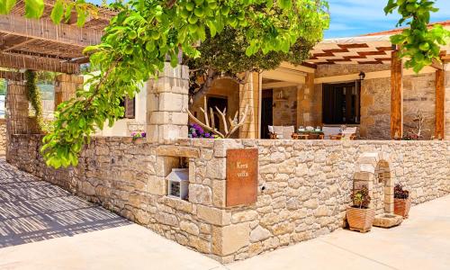 a stone wall in front of a house at Cretan Kera Villa Heated Pool in Kerá