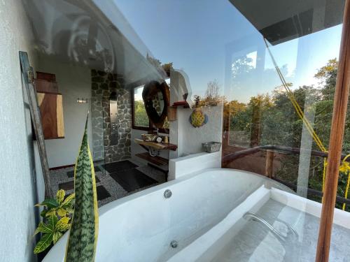 a bath tub in a bathroom with a large window at Havasokk in Francisco Uh May