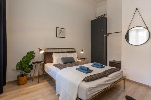 a bedroom with a bed with two blue towels on it at Deluxe Downtown Home by Elisabeth in Budapest