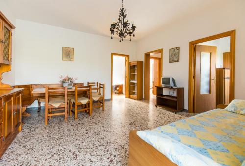 a bedroom with a table and a dining room at Residenza Piccolo Uliveto in San Menaio