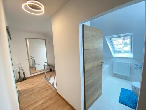 a bathroom with a glass shower door in a room at Ferienwohnung Fuchs in Himmelkron