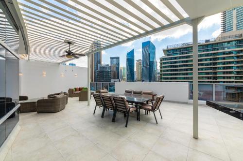 a dining room with a table and chairs on a building at Maison Privee - Stunning 3-Floor Villa with Kids Room & Rooftop Terrace over Dubai Marina in Dubai