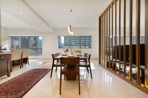 a dining room with a table and chairs at Maison Privee - Stunning 3-Floor Villa with Kids Room & Rooftop Terrace over Dubai Marina in Dubai