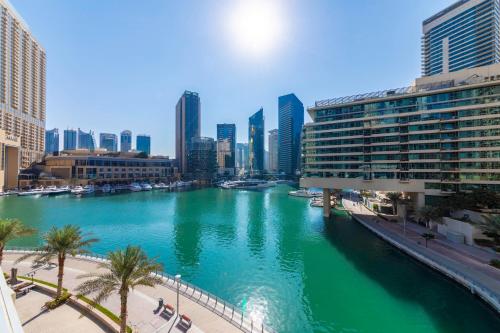 a river in the middle of a city with buildings at Maison Privee - Stunning 3-Floor Villa with Kids Room & Rooftop Terrace over Dubai Marina in Dubai